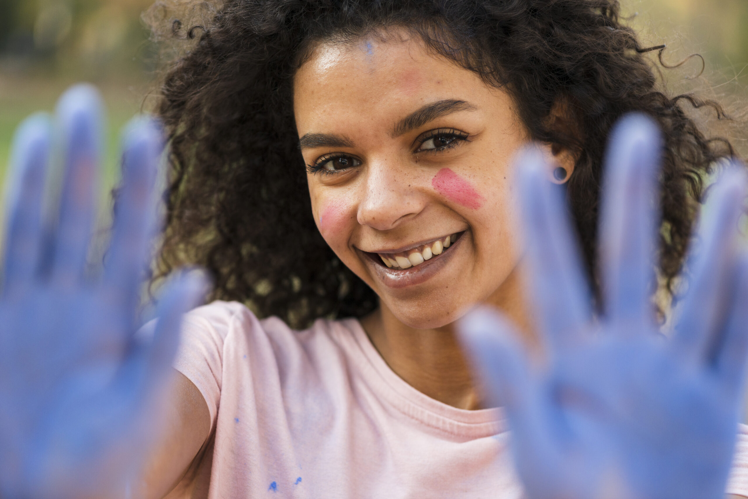 defocused woman showing blue covered hands